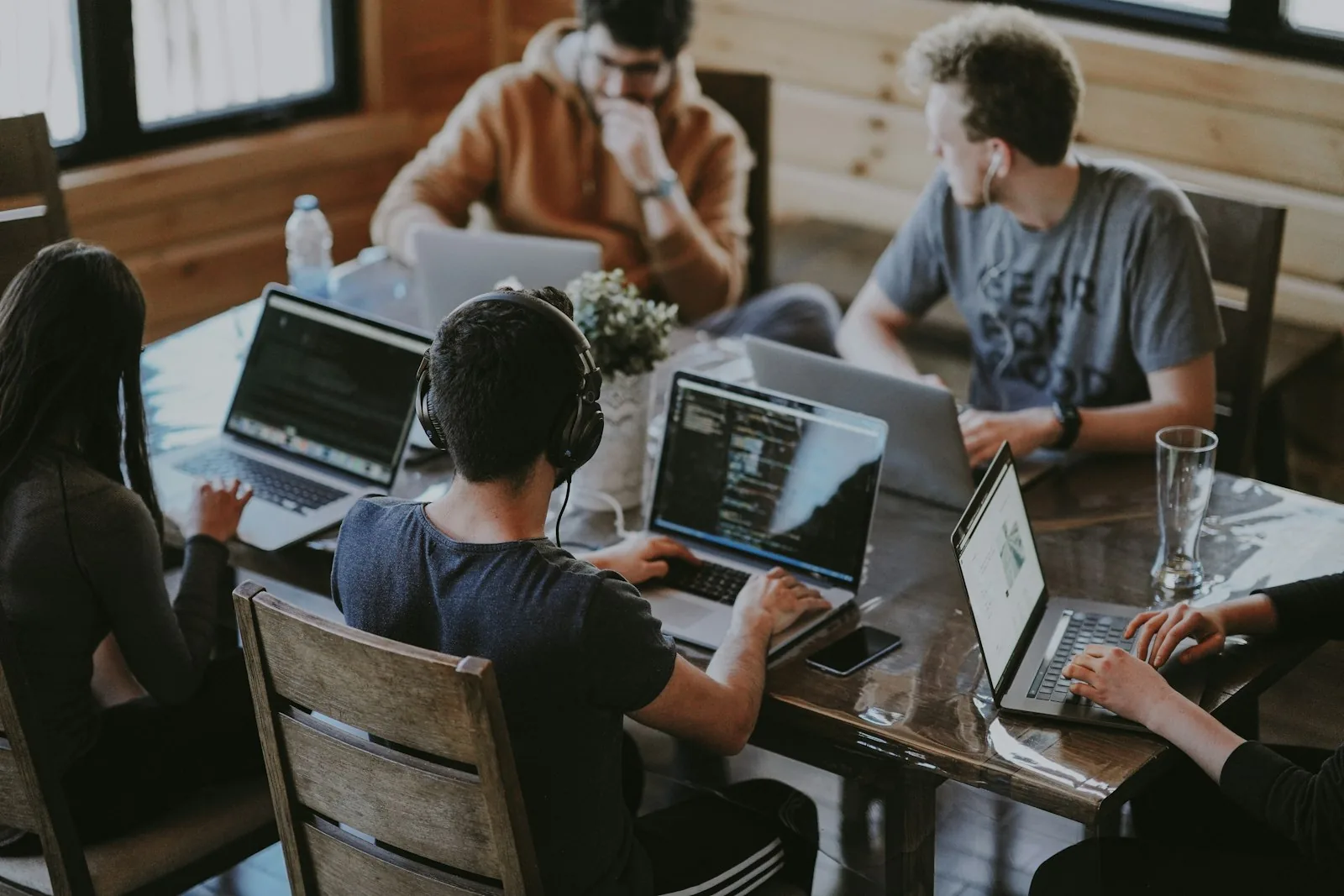 Colleagues working together around a shared table in a bright workspace